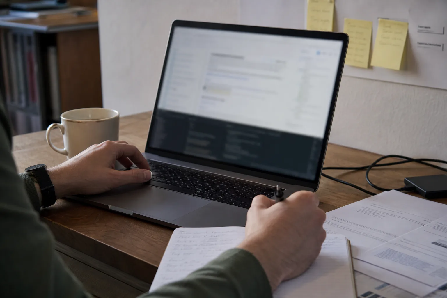 Consultant inspecting website delivery and technical discovery evidence on a laptop.